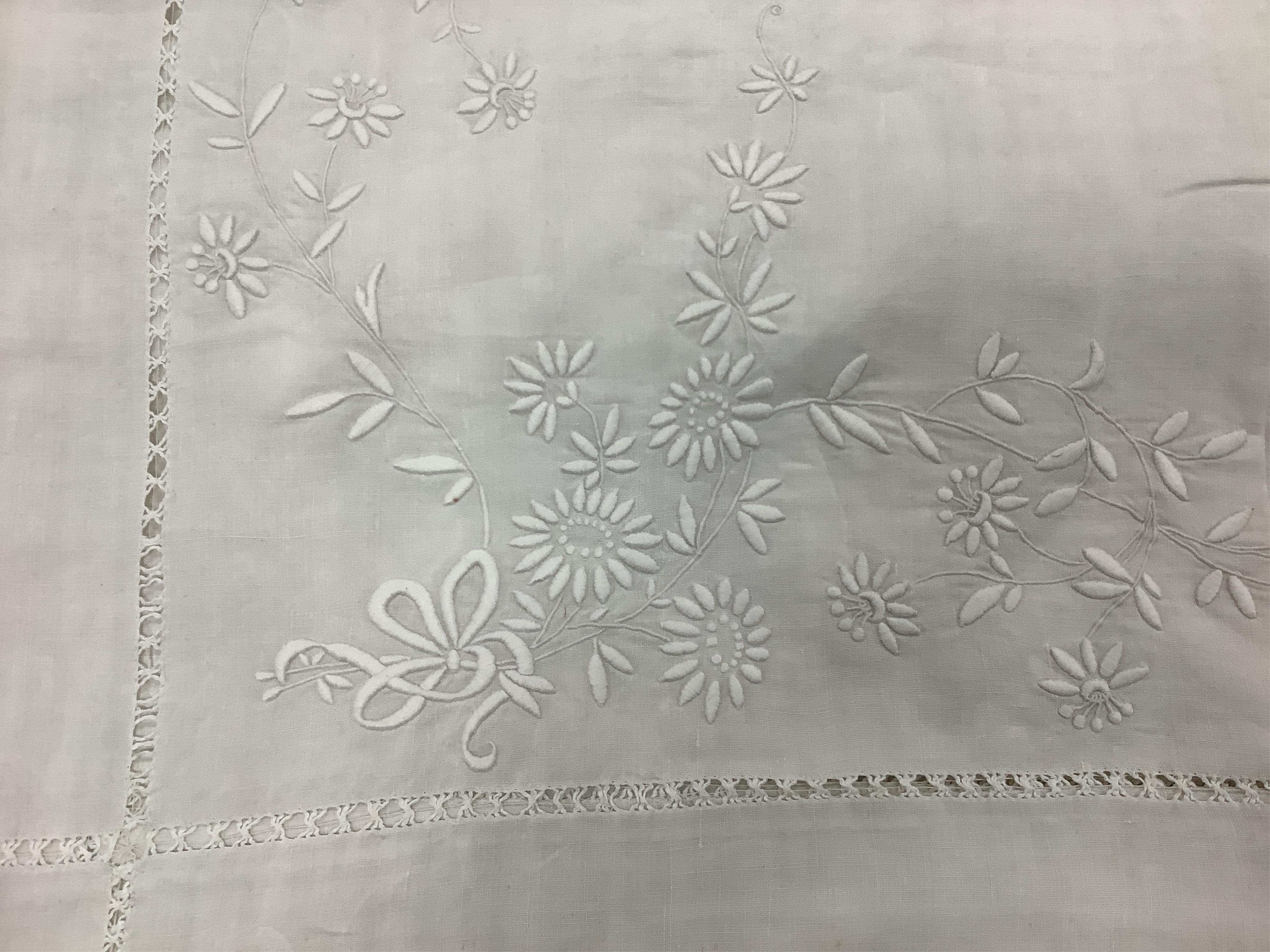 Four 19th century French provincial linen top sheets. Two with deep heavily floral embroidered turn backs, another with tear drops embroidered on the turn back, the other a narrower sheet with a single embroidered monogr